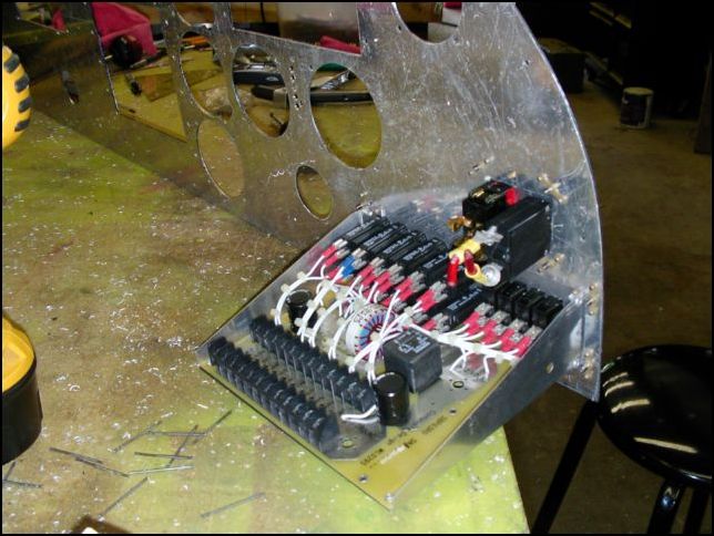 Cut holes for master switch and power panel.  Install nuts with flush rivets so this unit can be removed at any time with out the need to get behind the panel.