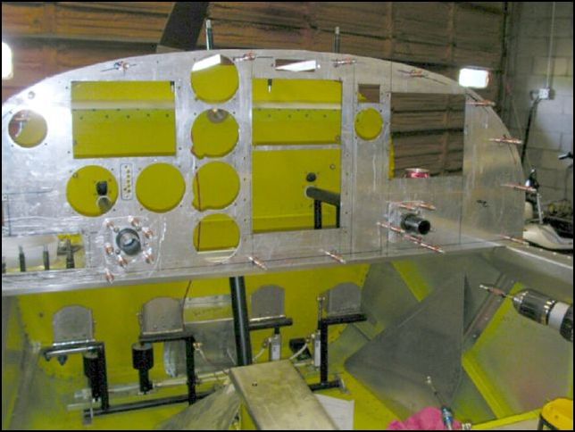 Slide bearings over yoke control rods.  Drill and cleco them in place.