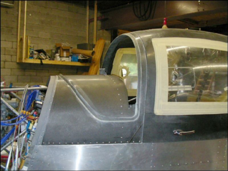 Remove the canopy, deburr all rivet holes, reinstall the canopy and rivet in place.  Do not rivet the handle to the center of the dash yet.  You will want to cover the dash first then install the handle on top of what ever you use to cover the dash.