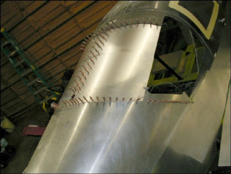 Drill the 2 inch vent hole and then drill and cleco the rear of the top skin.  Drill this from the inside while a helper holds a block of wood on top.  Again, start in the middle and work your way down both sides.