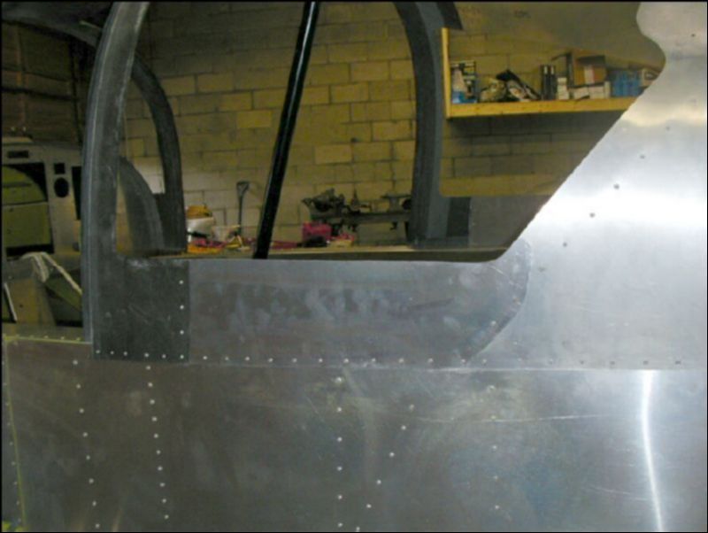 Deburr, clean, prime, and rivet the skins under the rear windows.