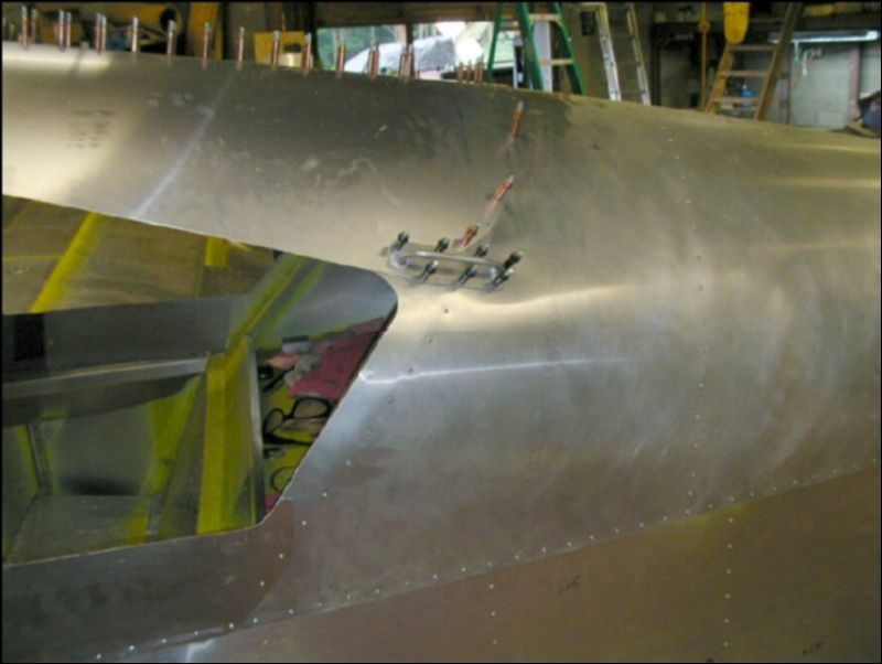 Drill and cleco the handles to the sides of the fuselage just above and behind the rear windows.  The drawings show A4 rivets but I used A5 to make sure these things don't pull off!