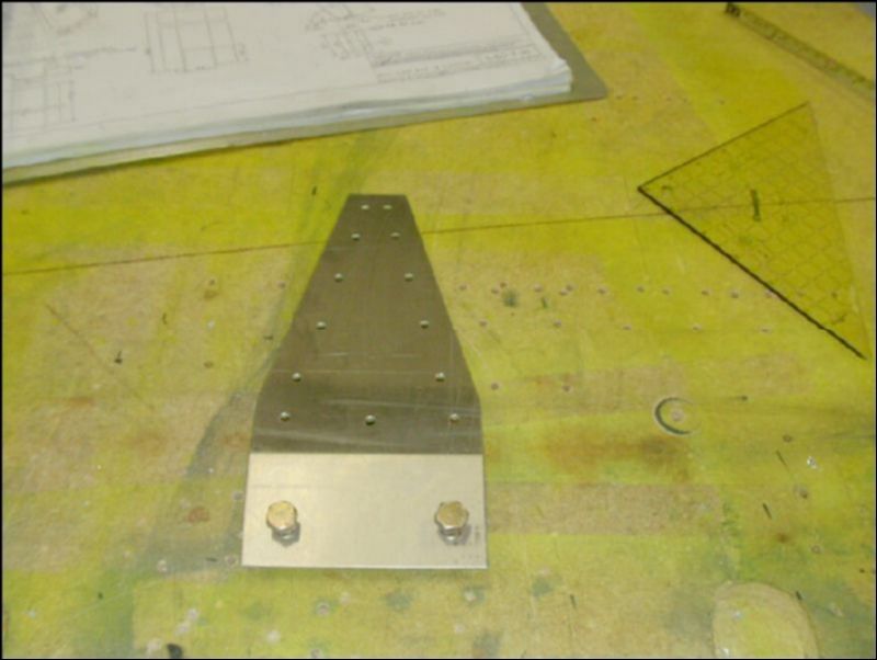 Drill the bolt holes and rivet holes in the rear seat belt attachment bracket.