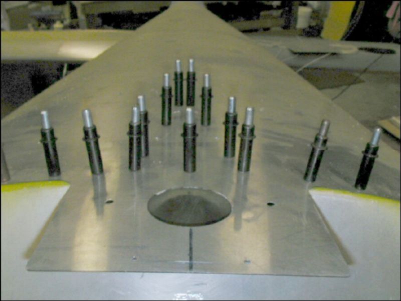 Drill and cleco the rear seat belt attachment bracket to the fuselage.  The front of the bracket sticks out in front of the bagage area bulkhead.