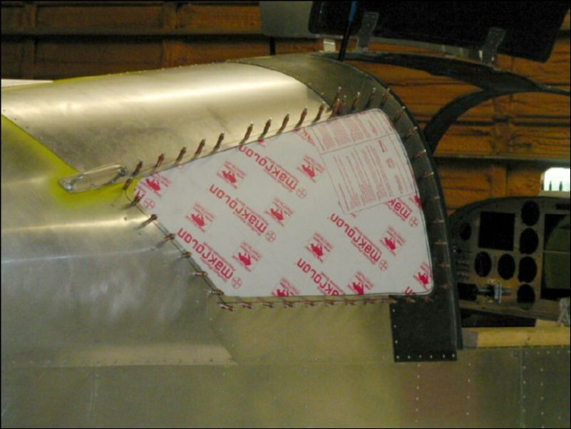 Have a helper hold the window from inside the cabin.  Drill and cleco the window in place.  A4 P50.  Then remove the window and enlarge the holes in the window only to A5 and deburr both sides of the holes in the window.  DO NOT enlarge the holes in the skin to A5.