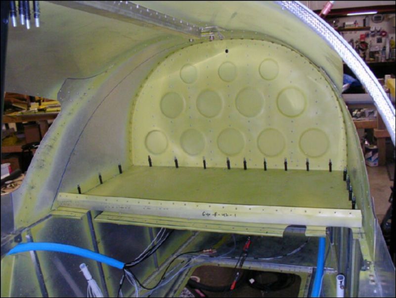 Cut back the baggage area floor, cut new slots for the flap motor bracket and step brackets.