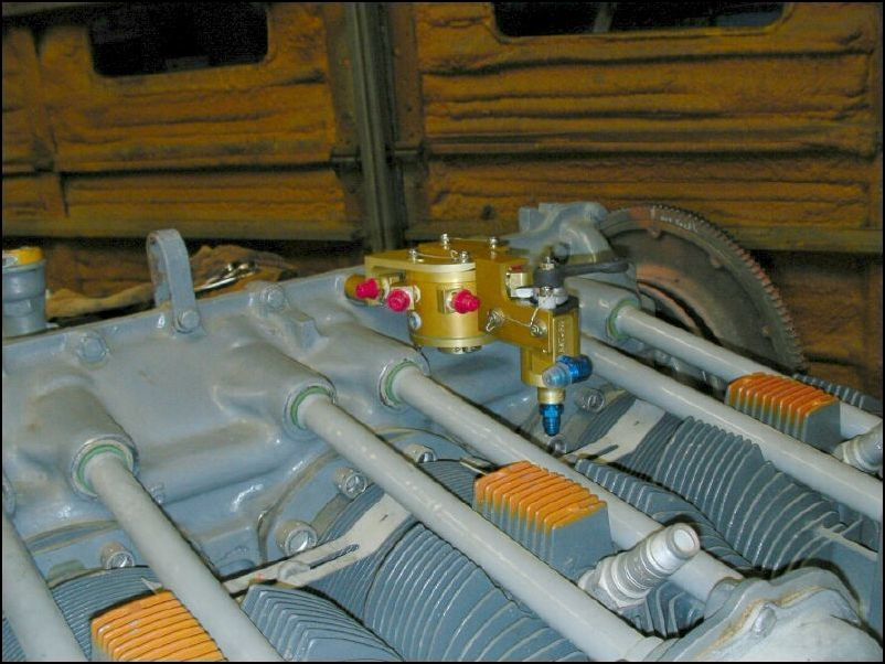 Bolted fuel injection fuel divider to the top of the engine.