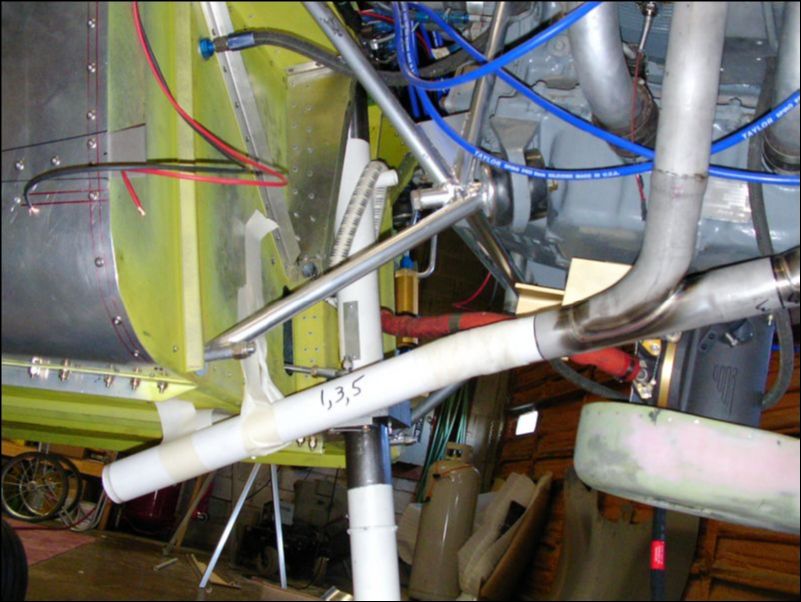 Bolt exhaust to engine and cut PVC pipe to form the extension.  Tape the pipe in place then cast it with gauze tape, baking soda, and super glue.  This makes a nice cast so that I can now send the exhaust pipes out to be formed and welded.