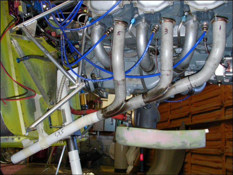 Bolt exhaust to engine and cut PVC pipe to form the extension.  Tape the pipe in place then cast it with gauze tape, baking soda, and super glue.  This makes a nice cast so that I can now send the exhaust pipes out to be formed and welded.