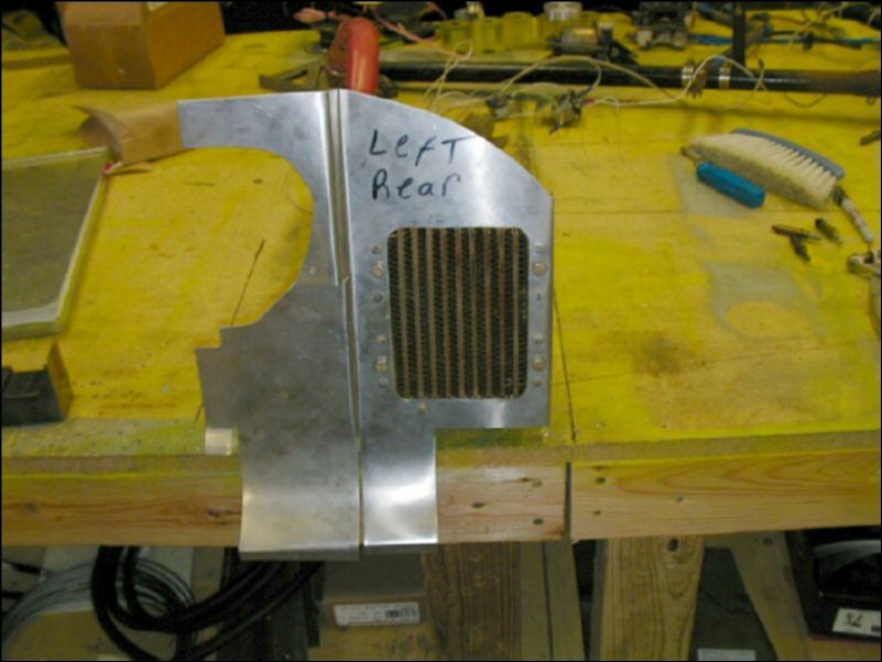 Bolt the oil cooler to the left rear engine baffle.