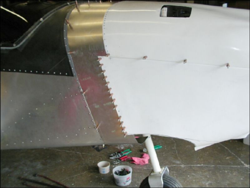 Cut out the bottom of the bottom cowling.  Drill and cleco the bottom cowling to the extension.  We still need to cut more of the bottom away before begining the fun job of trying to form a nice bottom cowling.