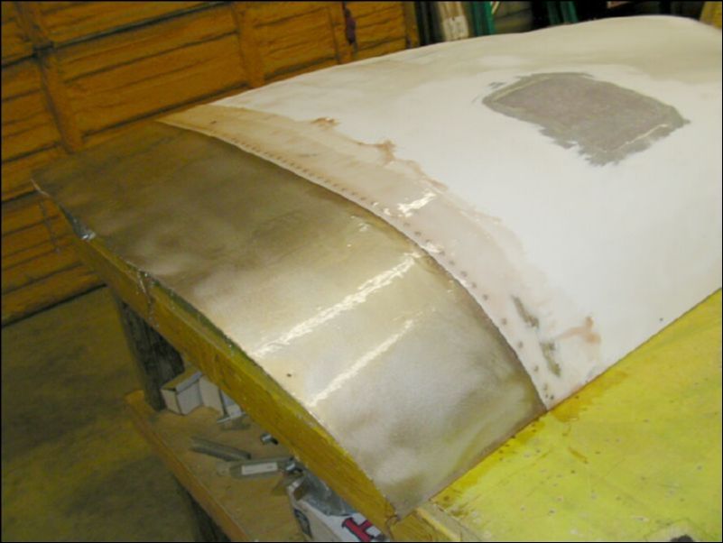 Glass over the top of the top cowling at the location where the original cowling over laps the extension.