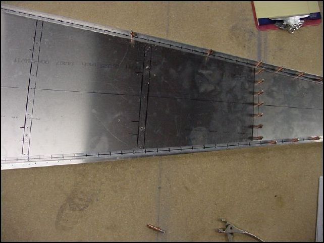 This is another image showing how the longerons look like they will not fit correctly.  They will though, don't worry.  Just pull on the middle of the longeron to line it up with the edge of the skin then drill and cleco it into place.