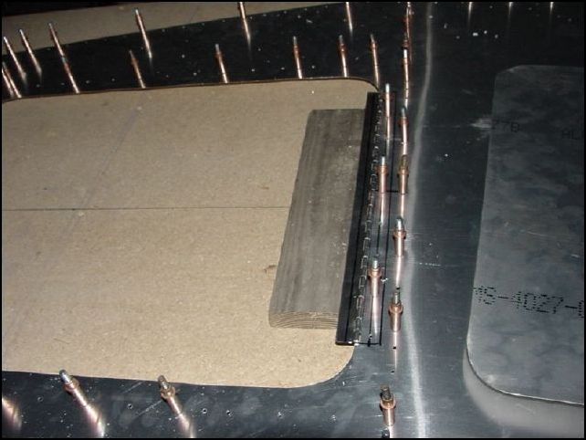 Center the access door hinge and drill rivet holes A4 P50.