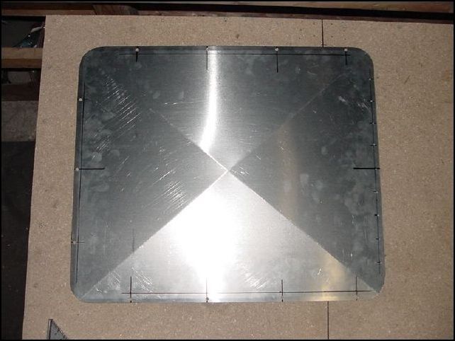 This is an image of all 11 1/4 inch bolt holes drilled in the access door.