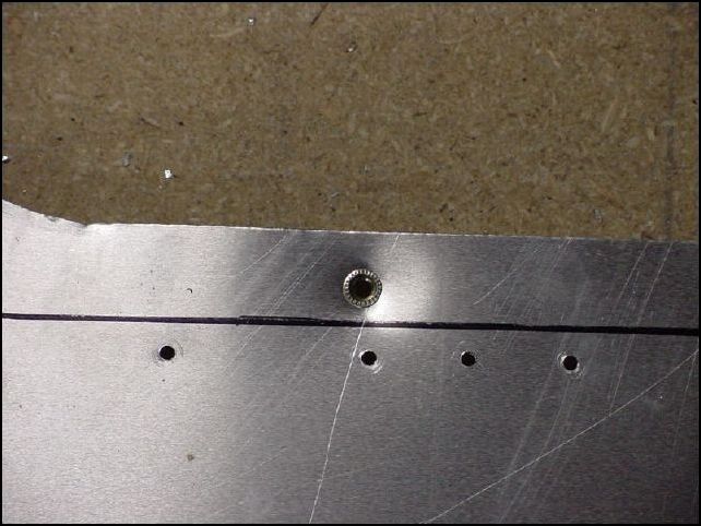 Line up the access door and mark the rivnut locations through the access door.  Then remove access door, drill holes, and install rivnuts in skin.  Note that they do NOT go in the Z angles as the drawings show them.