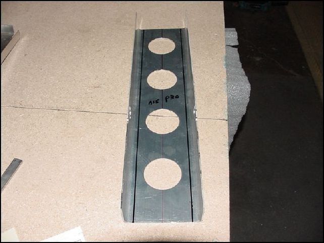 Draw center line on 20-F-16-3 (center channel).  Mark 15 mm from each side and draw line for rivet holes.  Mark rivet locations AS 5 P30 on these two lines.  Place channel on firewall, line up bottom, clamp, drill, and cleco in place.