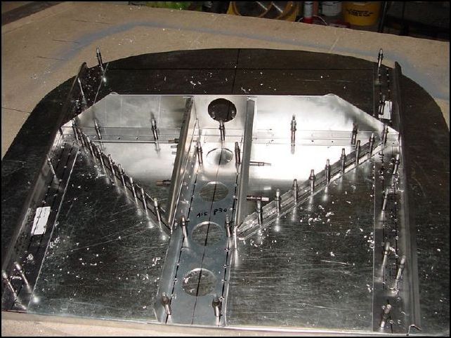 Sorry, this image does not show this, however you now need to drill two rivet holes through the gear angles into the upper horizontal Z.  One rivet hole near the bottom and one in the center.  The top will be riveted later during assembly of the fuselage.