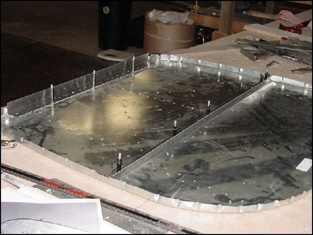 Remove all the parts from the front of the firewall.  Turn firewall over.  Mark center line on the bottom back of 20-F-14-4 (upper horizontal firewall angle).  Place this part on the firewall and clamp in location over the holes for the standard L.  Then flip firewall over and drill through the standard L holes into the upper horizontal firewall angle.  You will also drill two more holes left and right AS 5 P40.  Draw center line on 20-F-14-5 (lower horizontal firewall angle).  Mark rivet hole locations AS 5 P30.  Be sure NOT to drill rivet holes in the engine mount hole location.  Position this part at the bottom of the firewall.  Drill rivet holes, cleco as you drill.  Once you have this done you can flip the firewall over and drill the engine mount pilot hole through this part from the pilot hole you already have on the other side.