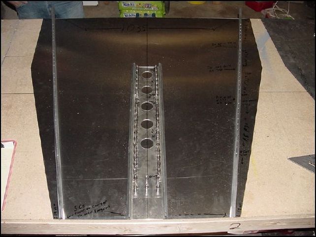 Position longers to cabin floor skin. The front part of the longerons will be bolted to the engine mount fittings.  Therefore you want to make sure that you end up with 565mm center to center of the longerons.  To do this measure 19mm in from left and right at the front and 48mm in left and right at the rear.  Line the longerons up on these marks.  The rear of the longerons at the edge of the skin should be 1035mm apart.