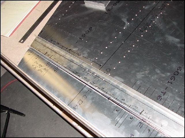 Draw rivet line on the floor channel about 12 mm from each edge.  Then from the center measure left and right 40, 40, 40, 50, 40, 30.  The drawings say A5 P40, however if you do this then your rivets will end up in the do not dirll zones.  Drill and cleco in place.