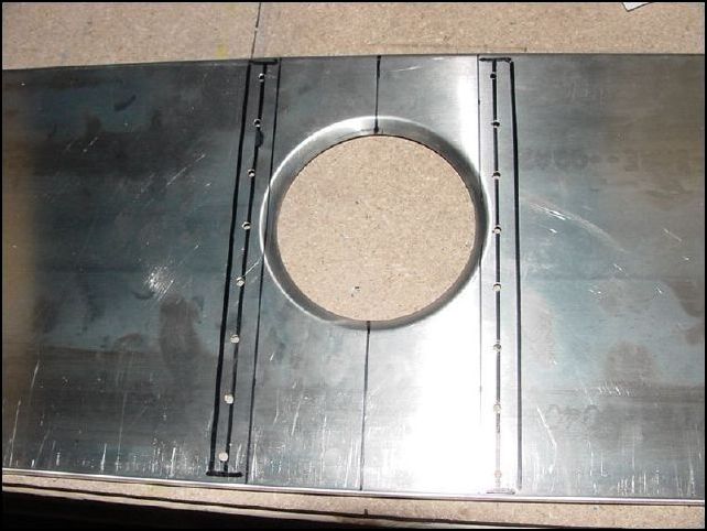 Position 20-F-15-2 (torque tube support side wall) to the forward Z and draw a line to mark the edge of it's flange.  Mark and drill  8 A5 rivet holes P31 for both the left and right supports.