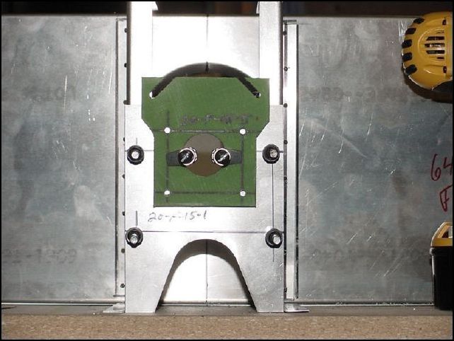 Drill 20-F-15-5 for A6 rivets.  Position 20-F-15-5 so that the bearing hole is lined up with the front panel hole on 20-F-15-1.  Now drill through 20-F-15-5 into 20-F-15-1 for the 4 A6 rivet holes.  The IPL says to drill 3/16