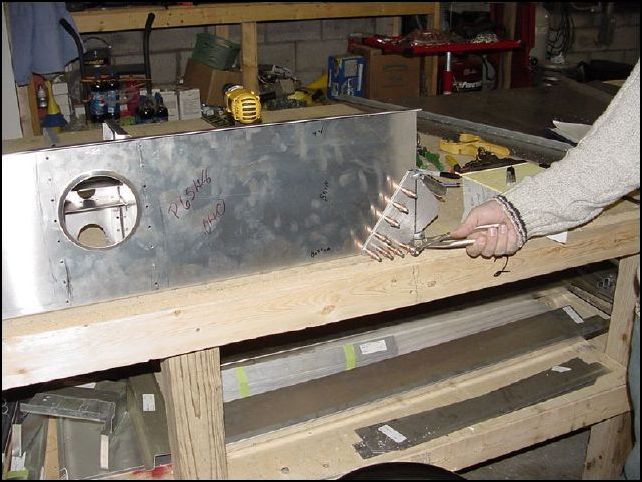 Drill and cleco front wing attach brackets to front Z for AD4 rivets.