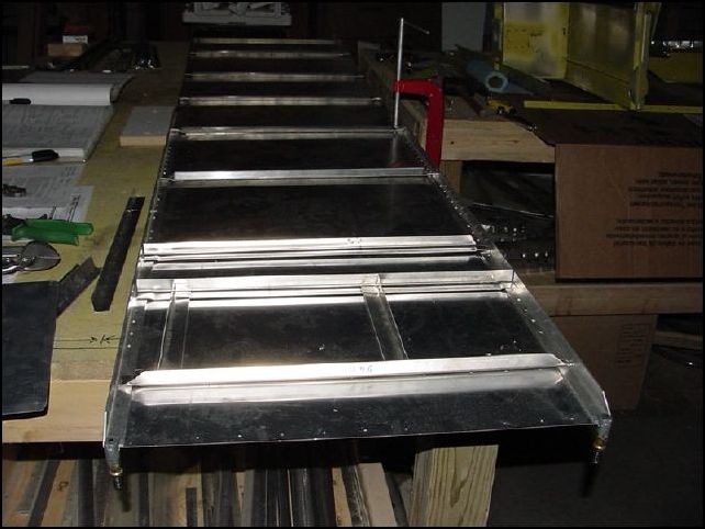 Note:  The longerons I have clamped to the skin are not the correct ones, I just used them to space the Ls and Zs.  This image is a rough layout of the left side skin.  My skin was pre-punched at the factory.  So I started by confirming the locations of the pre-punched holes to the drawings.  Well, most of them are ok, but it looks like this skin was punched for the CH-2000 which does not have a rear seat.  This means that the holes for my rear upright channel are punched incorrectly and I will have to figure out a way to correct this when I install that part.