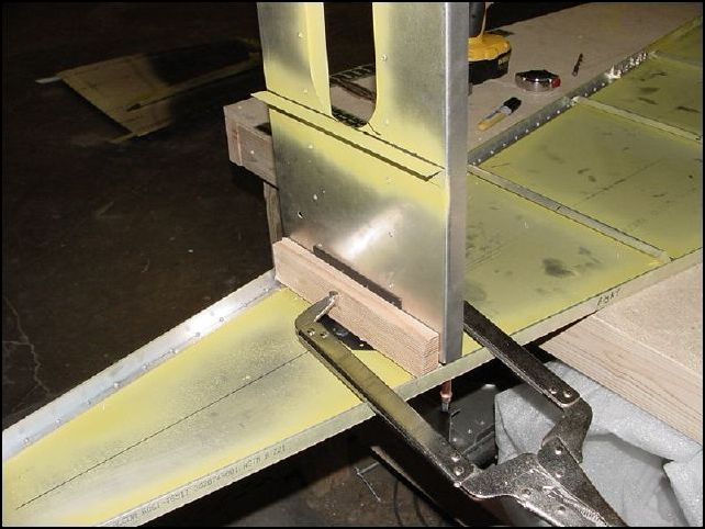 Clamp the HT frame and stiffener in place and drill the bottom rivet holes for the HT fram through the bottom skin.