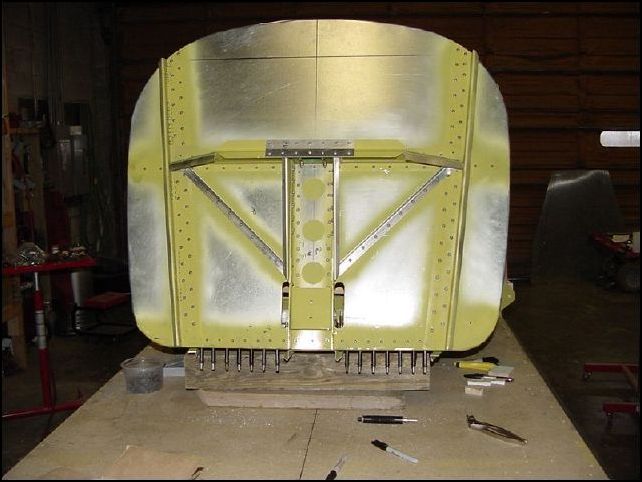 Drill A5 rivet holes for firewall to cabin floor.  Do not drill in the center channel area at this time.