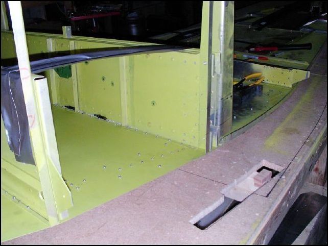 Rivet the doubler and longerons in place.  Notice that the first three rivets in front of the center channel are solid rivets and you also have a row of solid rivets behind the center channel back to the location of the rear seat channel.  The channel is not installed yet.  DO NOT INSTALL THE SOLID RIVETS behind the center spar yet.  I had to drill mine out to install the main gear brackets.  Don't make the same mistake that I made!