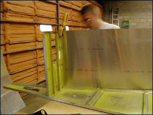 Position the side skin so that the rear of the skin is flush with the rear of the HT assembly, the front will  line up with the FRONT of the rear upright on the center channel, and the bottom of the skin lines up with the bottom skin.  Clamp the skin in place for now.