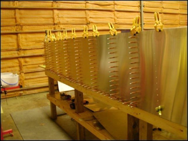 Clamp, drill, and cleco Ls and Zs to right lower side skin.