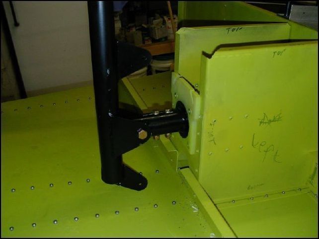Assemble the torque tube and control column.  Assemble on a bench first and it will help if you have a jig for a drill press to drill the two bolt holes that hold the control bearing to the torque tube.  ALSO, be sure to install the bushing in the torque tube in the front hole for the control column.  WHEW, now take the assembly apart and install into the fuselage.