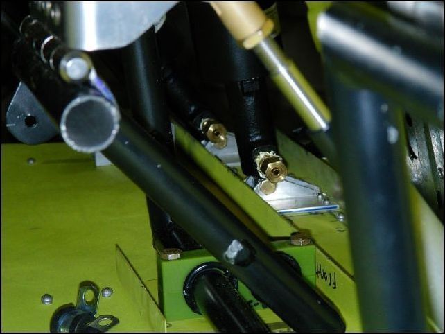 Install brake line fittings to cylinders.  This image shows the fittings for the master cylinders on the pilots side.