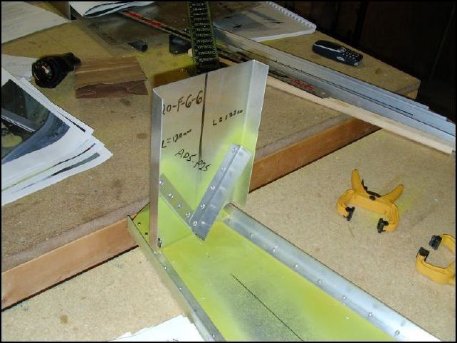 Position the assembly to the rear of the fuselage on top of the lower top rudder hinge.  Bolt or solid rivet together.