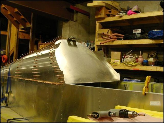 Well, I just found out that I do not have the parts I need to make the baggage compartment, so I will have to do that after the parts arrive.  So, I installed bulkhead 3 to the front of the top skins.  Starting at the top drill a hole in the center of the top skin and in the center of the bulkhead.  Be sure that the bulkhead is lined up with the front of the skin.  Then work your way down each side just like you did for the other bulkheads.  The angle of this bulkhead is not important, but keeping it lined up with the skin is VERY important.