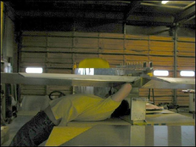 Since the fuselage is still on the workbench.  This is the position I had to be in to get the bolts through the wing hinge.  Can you say OUCH!  My back is killing me now.