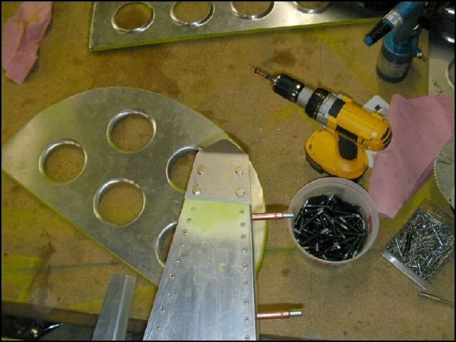 Deburr, clean, and prime all the skin parts and bulkheads.  Bolt top rudder hinge to top longerons.