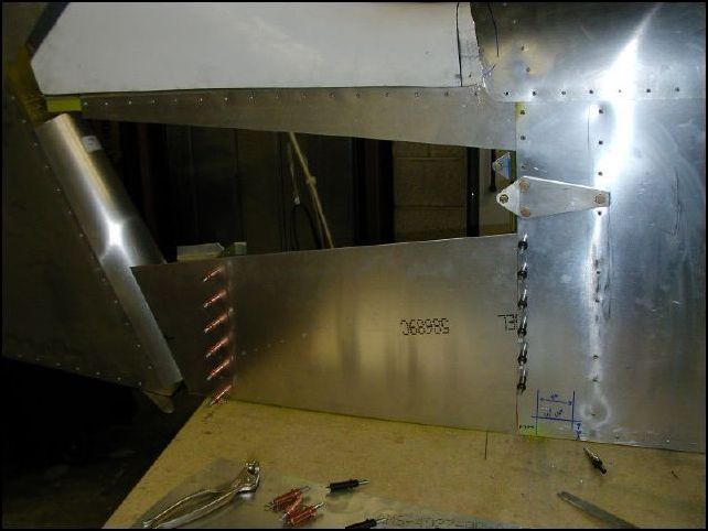 Position lower tail skin to fuselage, drill and cleco in place.