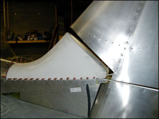 I did not like the HUGE gap between the tail saddle and the rudder so I re-installed the tail saddle so that I could make an insert to be glassed over for a better fit.