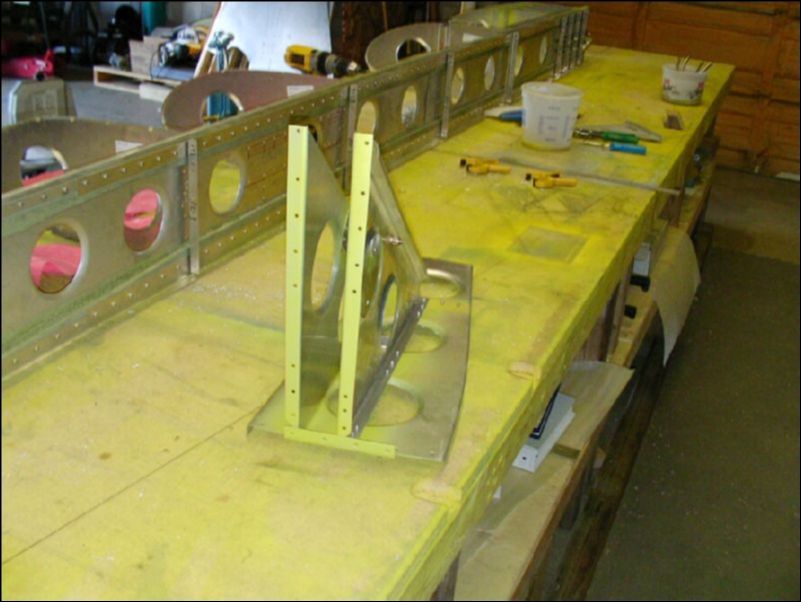 Deburr, clean, prime, and rivet the aileron bellcrank assembly.