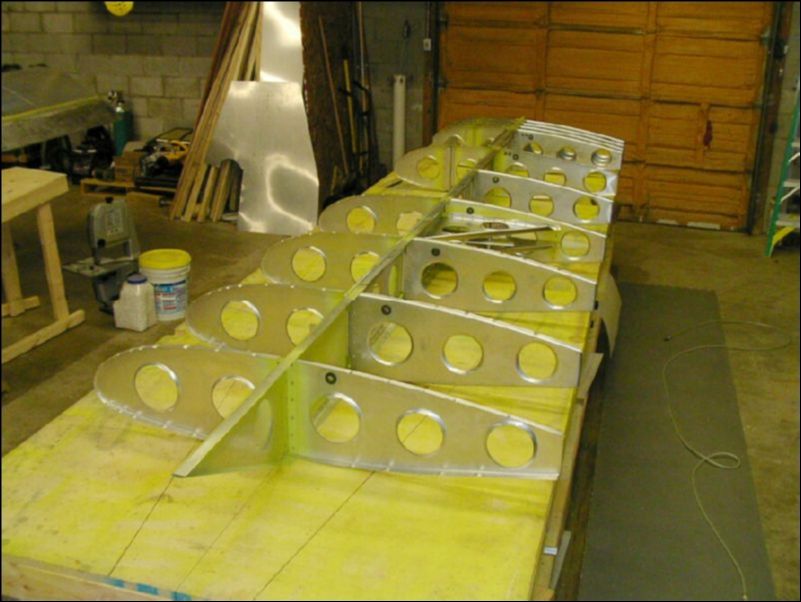 Rivet all ribs to the wing spar.