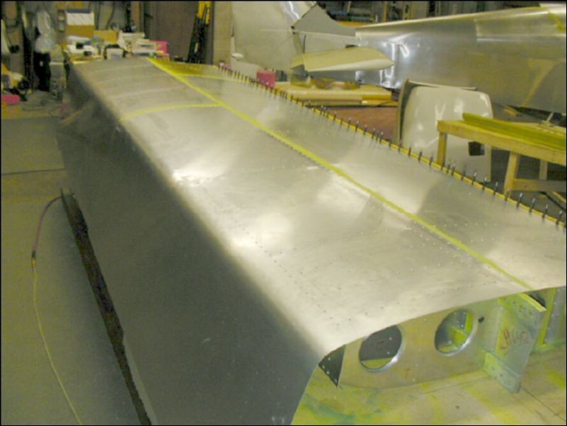 Deburr, clean, prime, and rivet all bottom skins.  Do not rivet to rear channel yet.