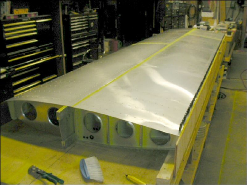 Deburr, clean, prime, and rivet all bottom skins.  Do not rivet to rear channel yet.