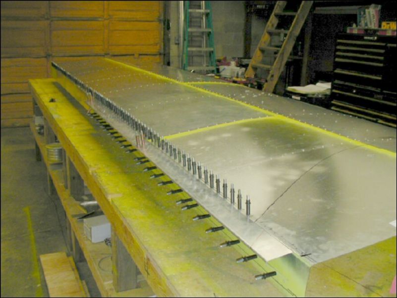 Slide aileron support under skin.  Drill and cleco in place.