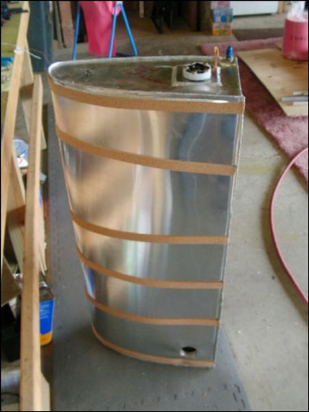 Install fuel sender, fuel fitting, and cork strips to fuel tank.  Safety wire the fuel sender bolts.