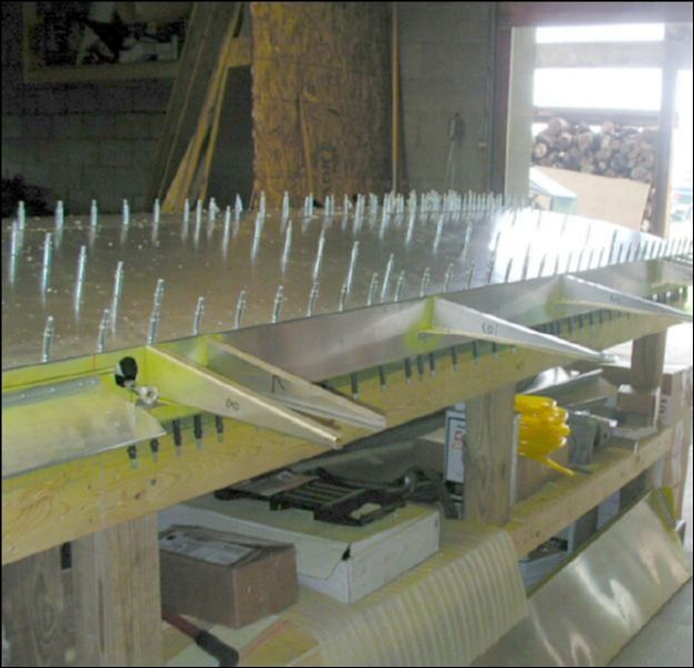 Install riblets over flap area and rivet.