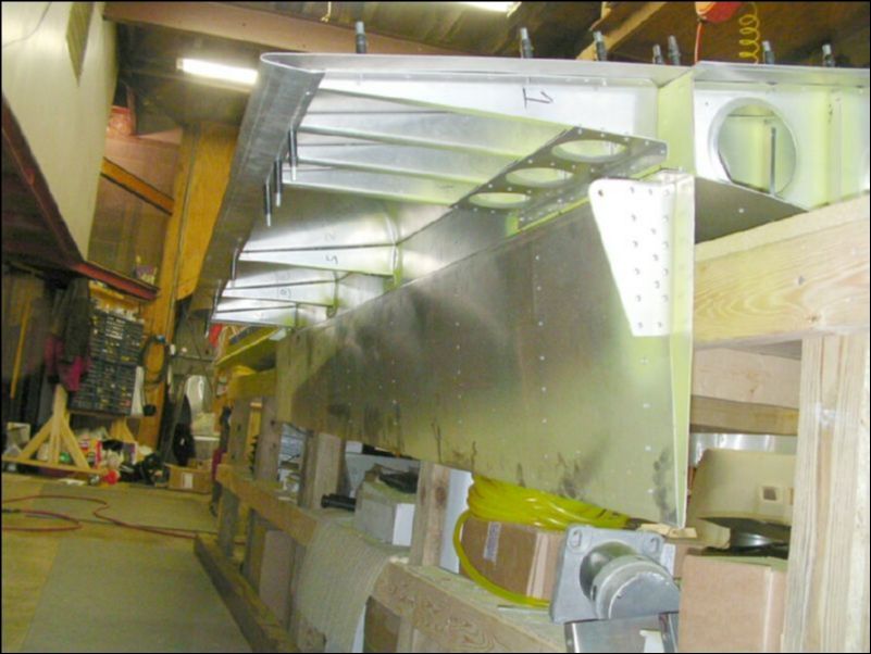 Slide the flap hinge under the rear bottom skin.